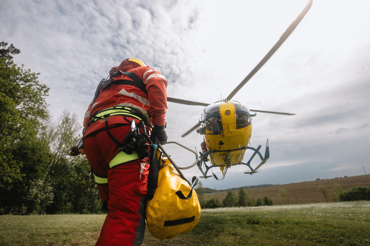 Paramedic running to helicopter of emergency medical service