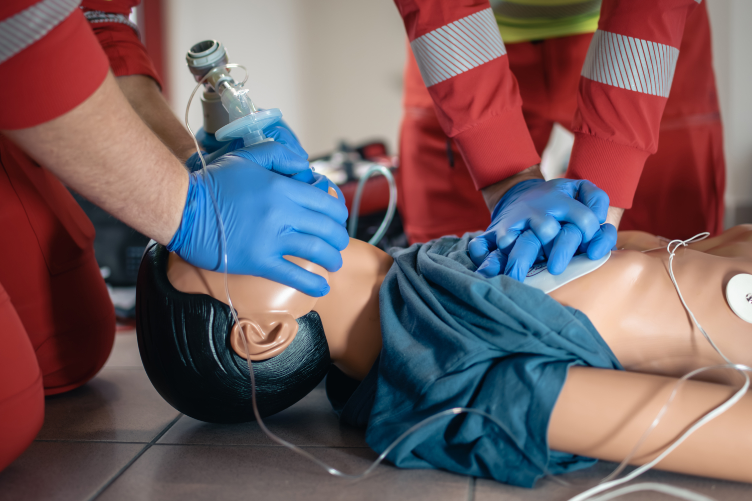 Team of emergency medical service during CPR training on dummy